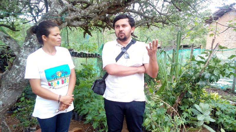 Carlos-explaining-about-the-cisterns-and-farmer-Celia-looking-on