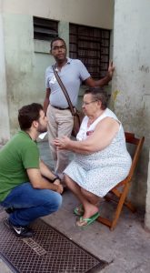 Dr. Rodrigo D'Aurea being greeted by yet one of his elderly patients on the street. The community health worker looking on.