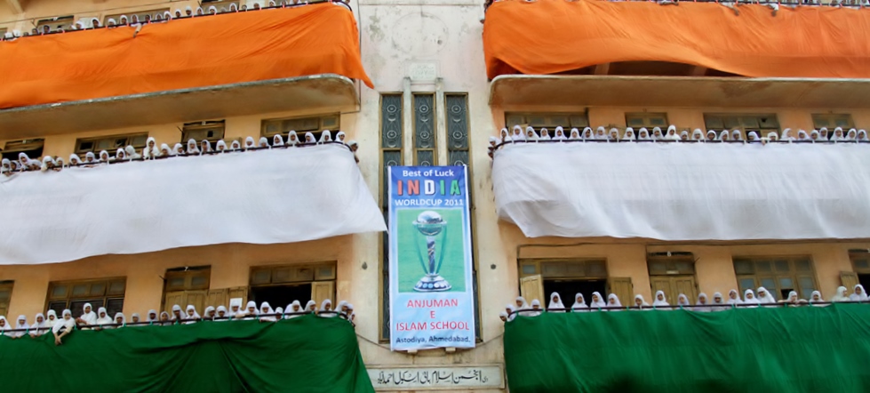 School children in a school in Ahmedabad dress up themselves and decorate their school building premises in the tricolor Indian flag to cheer for the Indian Cricket Team.