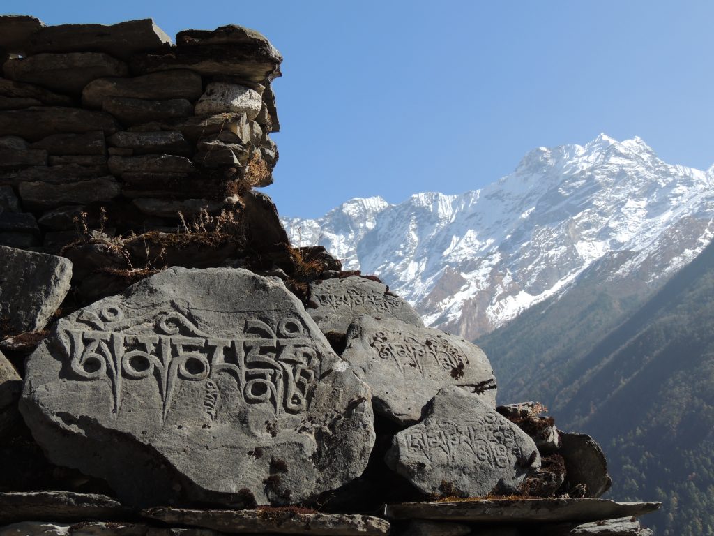 Hand-Carved Prayer Stone with Mountains in the Background