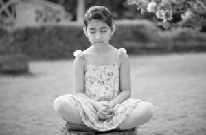 A child practicing Heartfulness Relaxation